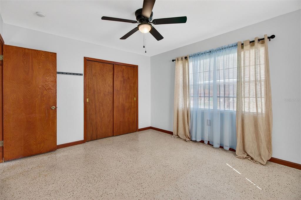 1541 Illinois Road Clearwater, FL 33756 - Photo 27 of 44 an empty room with chandelier fan