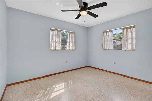 an empty room with windows and closet