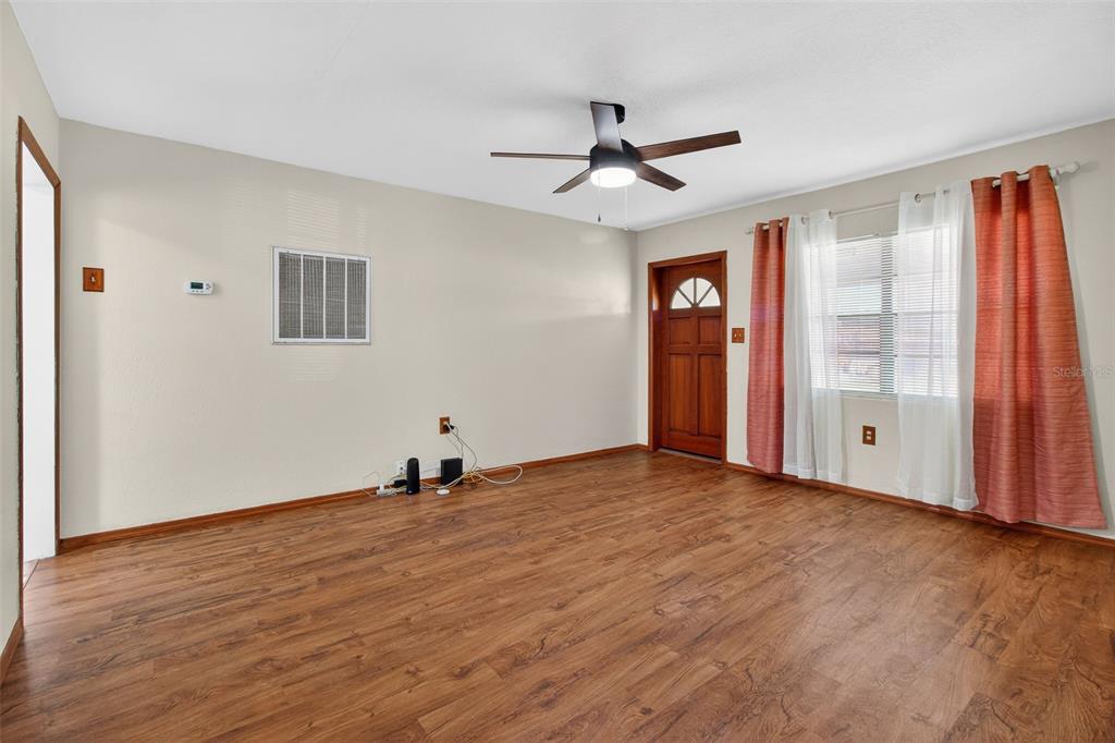 1541 Illinois Road Clearwater, FL 33756 - Photo 34 of 44 a view of empty room with wooden floor and fan