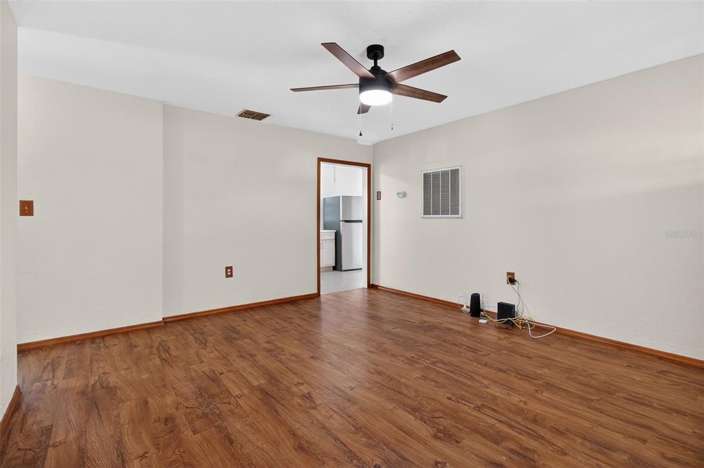 1541 Illinois Road Clearwater, FL 33756 - Photo 37 of 44 a view of a room with wooden floor and ceiling fan