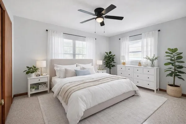 a bedroom with a bed couch and window