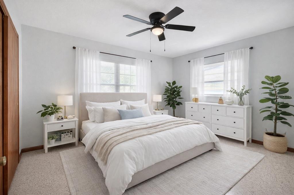 1541 Illinois Road Clearwater, FL 33756 - Photo 4 of 44 a bedroom with a bed and a chandelier