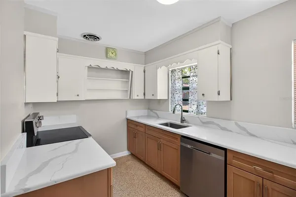 a kitchen with a sink a stove and cabinets