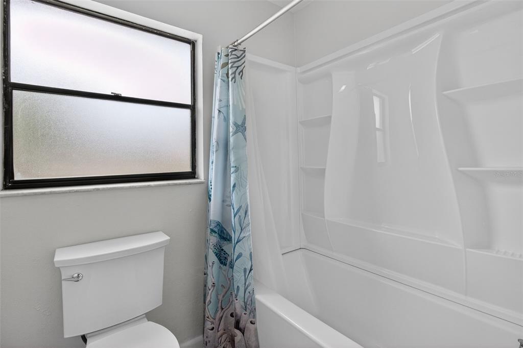 1541 Illinois Road Clearwater, FL 33756 - Photo 9 of 44 a bathroom with a toilet and a shower