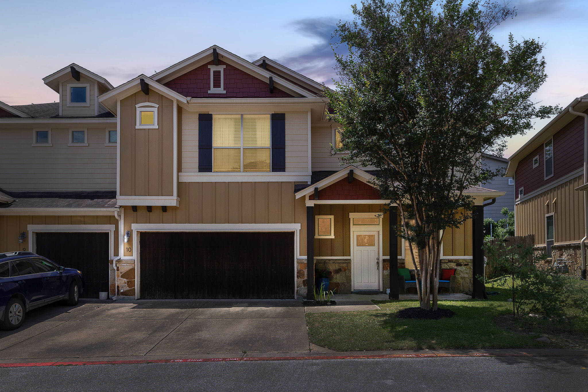 6708 Menchaca Road, Unit 10 Austin, TX 78745 - Photo 1 of 28 Contemporary two-story townhouse featuring a multi-textured facade with stone, horizontal siding, and vertical siding accents