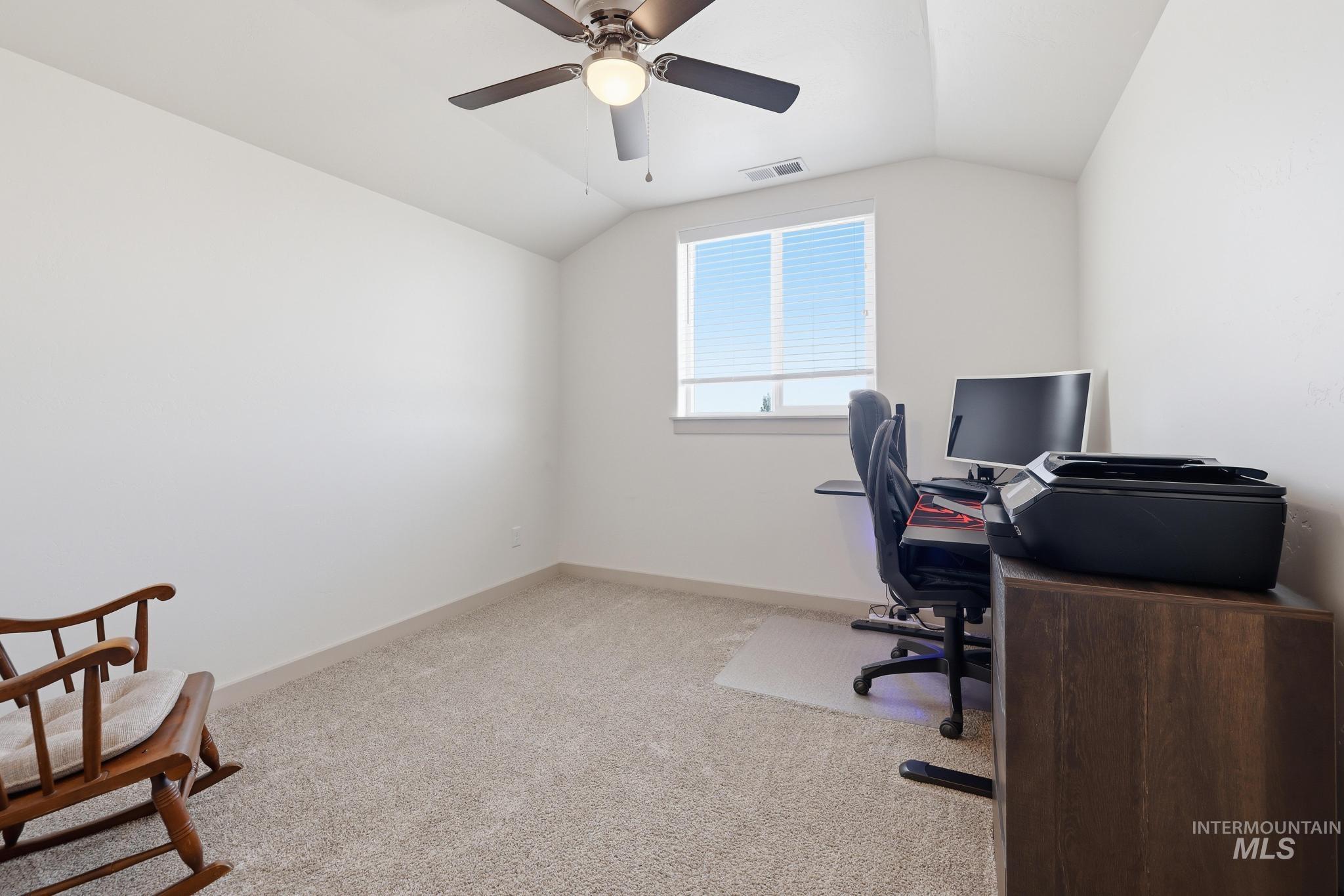 178 Syringa Loop Shoshone, ID 83352 - Photo 22 of 35 (Upstairs) - Currently being used as an office. Interior room featuring a ceiling fan with integrated lighting, natural light from a double-paned window, and neutral carpeting