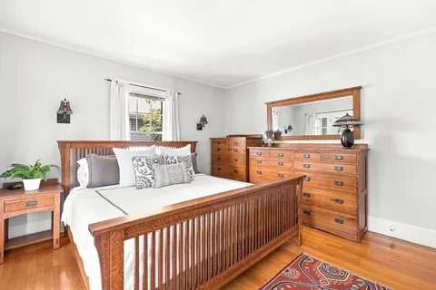 a bedroom with a bed and a dresser