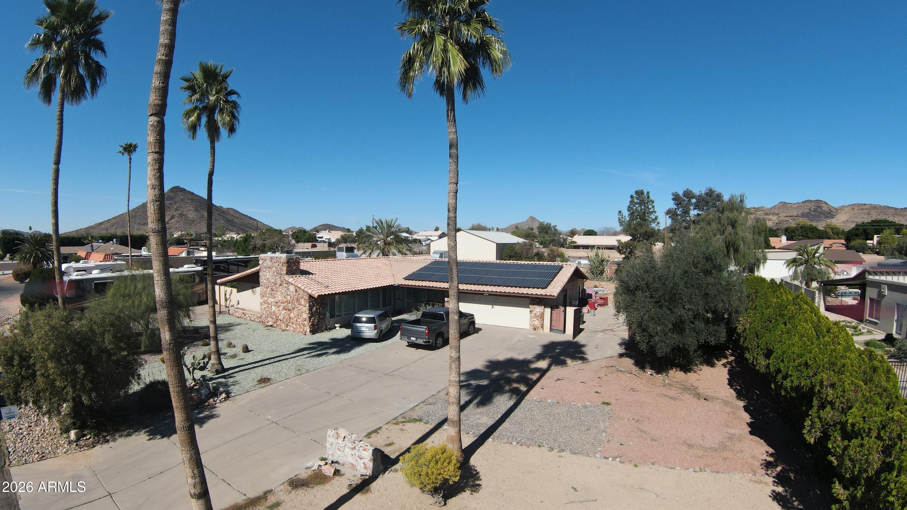 a view of a house with a backyard and a tree