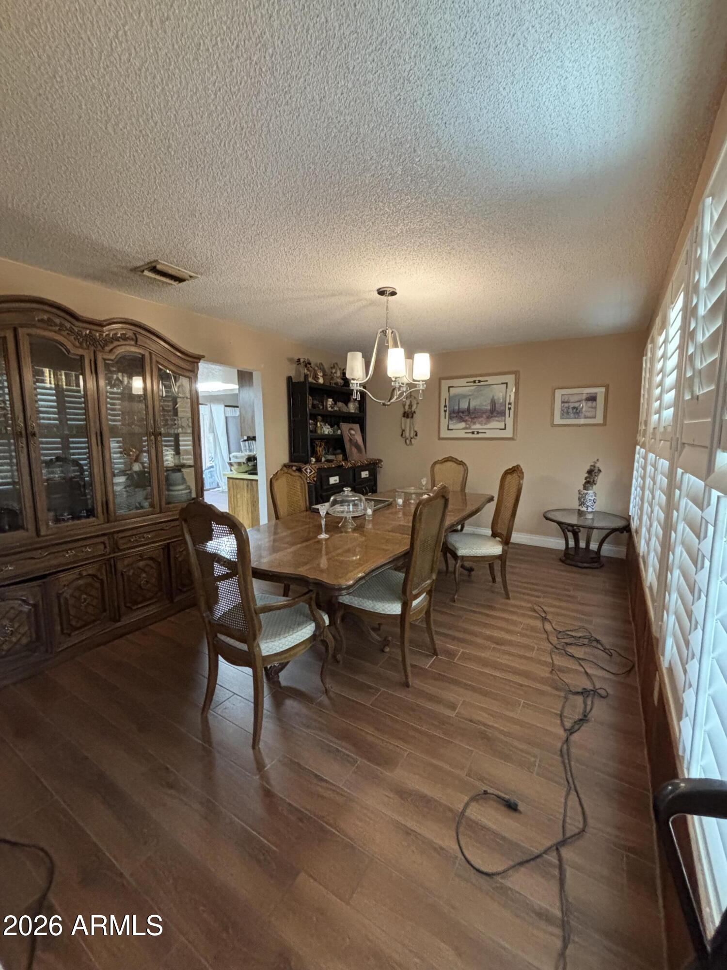 4934 West Fallen Leaf Lane Glendale, AZ 85310 - Photo 12 of 24 a view of a dining room with furniture window and wooden floor