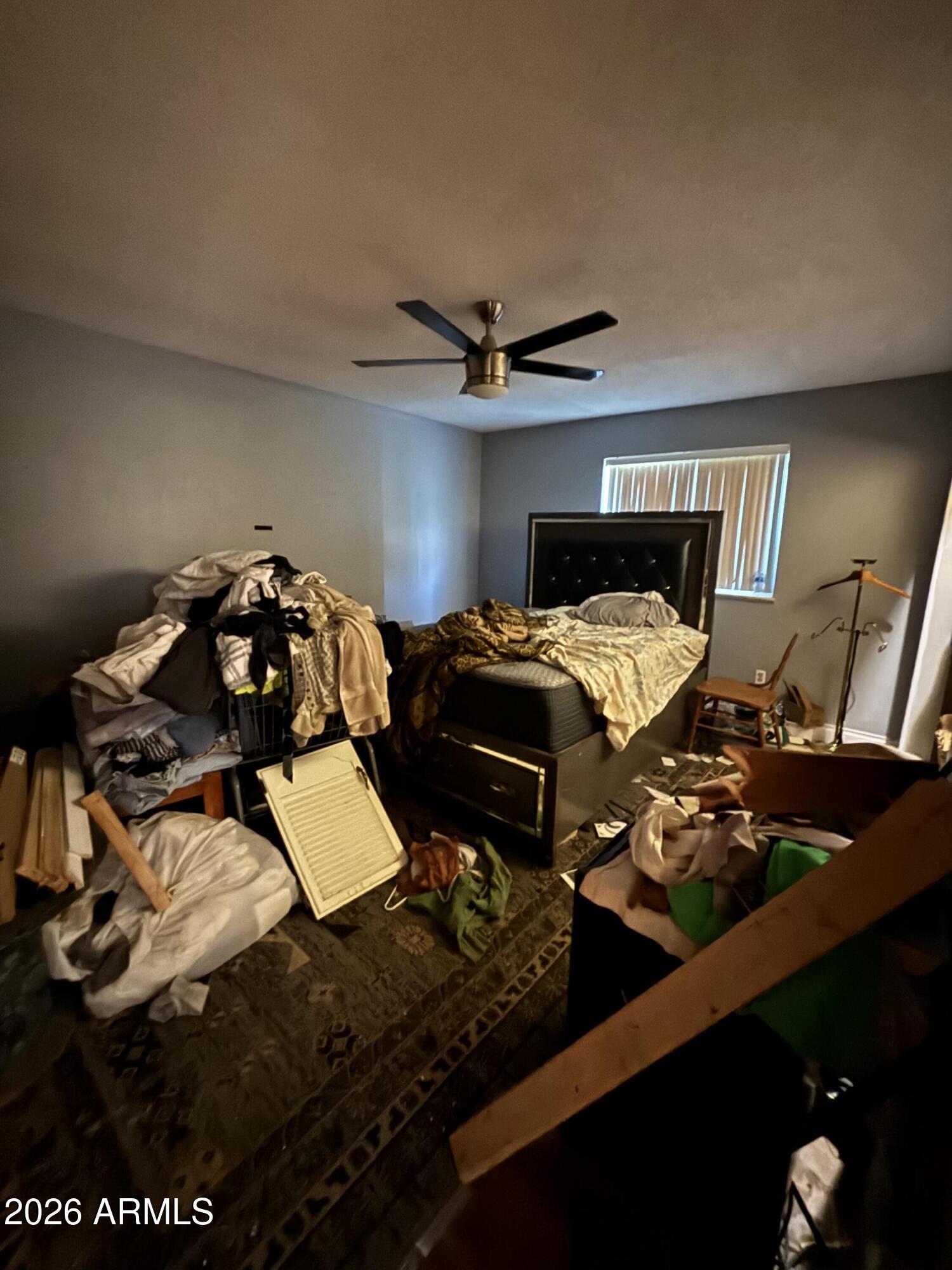 4934 West Fallen Leaf Lane Glendale, AZ 85310 - Photo 15 of 24 a bedroom with bed and a chandelier