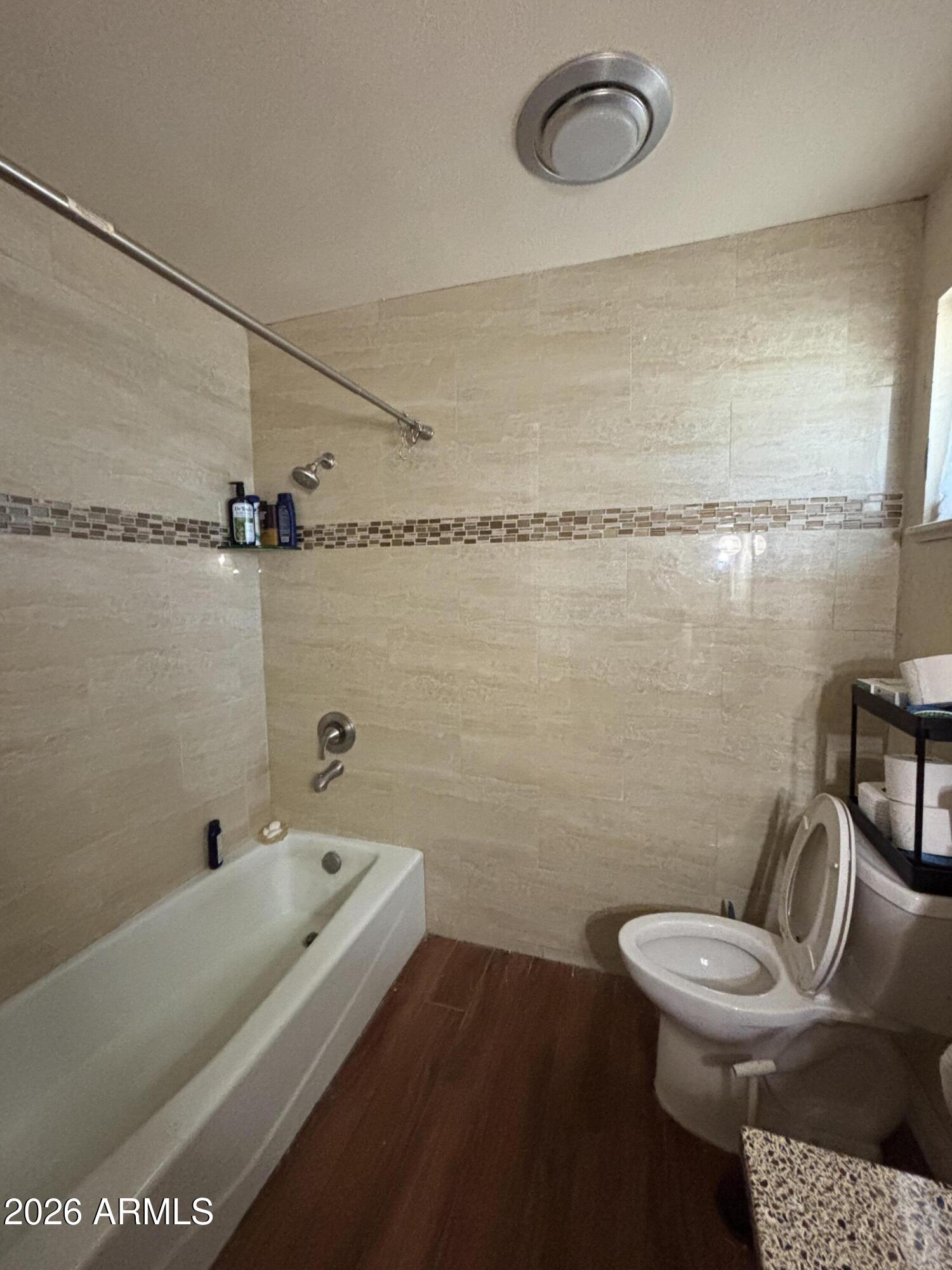 4934 West Fallen Leaf Lane Glendale, AZ 85310 - Photo 20 of 24 a bathroom with a granite countertop sink mirror vanity and toilet