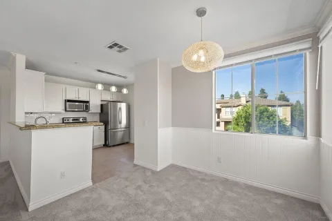 a view of a kitchen with window and stainless steel appliances