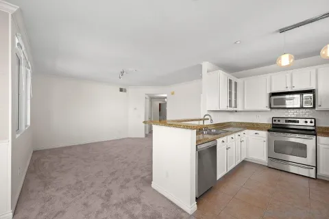 a kitchen with stainless steel appliances granite countertop a stove and a sink