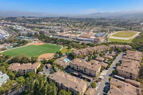 a backyard of a house with barbeque oven table and chairs