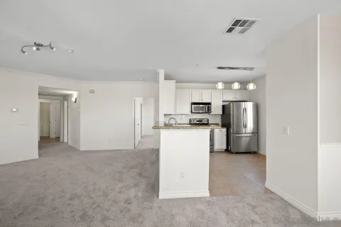 a view of kitchen with refrigerator stove microwave and cabinets