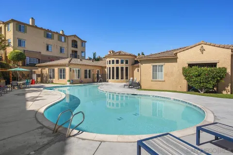 a view of a house with backyard sitting area and porch