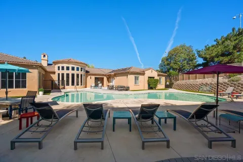 a view of a house with backyard porch and sitting area