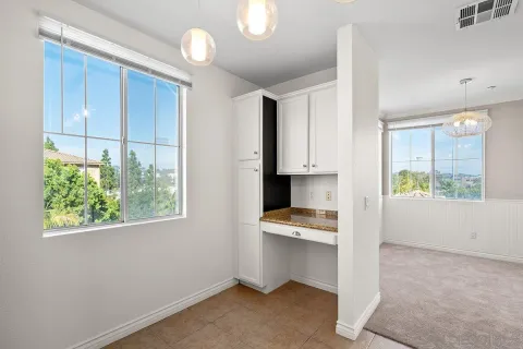 a view of kitchen with wooden floor and electronic appliances