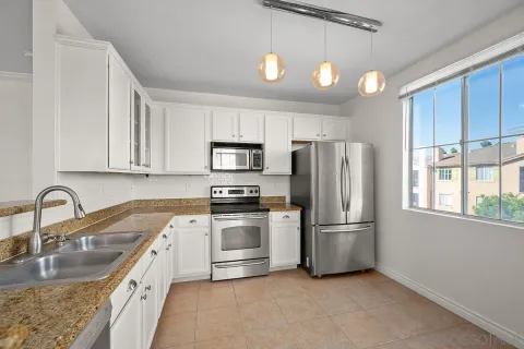 a kitchen with refrigerator a sink and cabinets