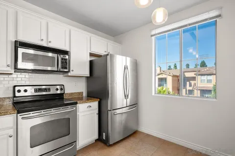 a kitchen with stainless steel appliances a stove microwave and refrigerator