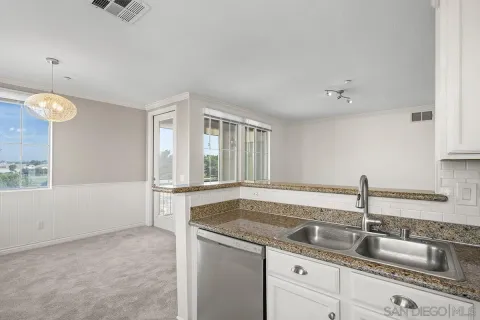 a kitchen that has a sink and cabinets