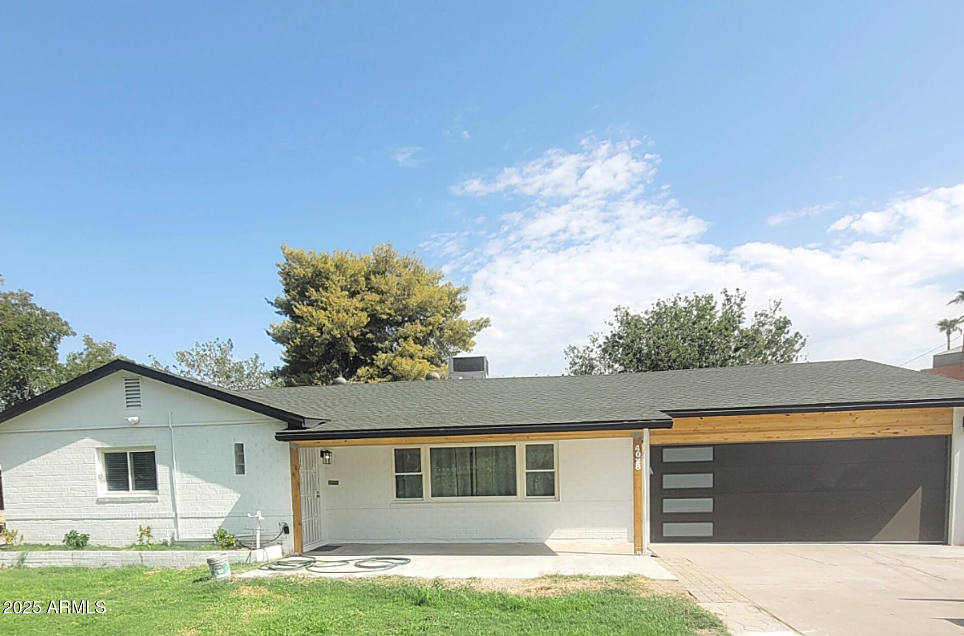 a front view of a house with garden