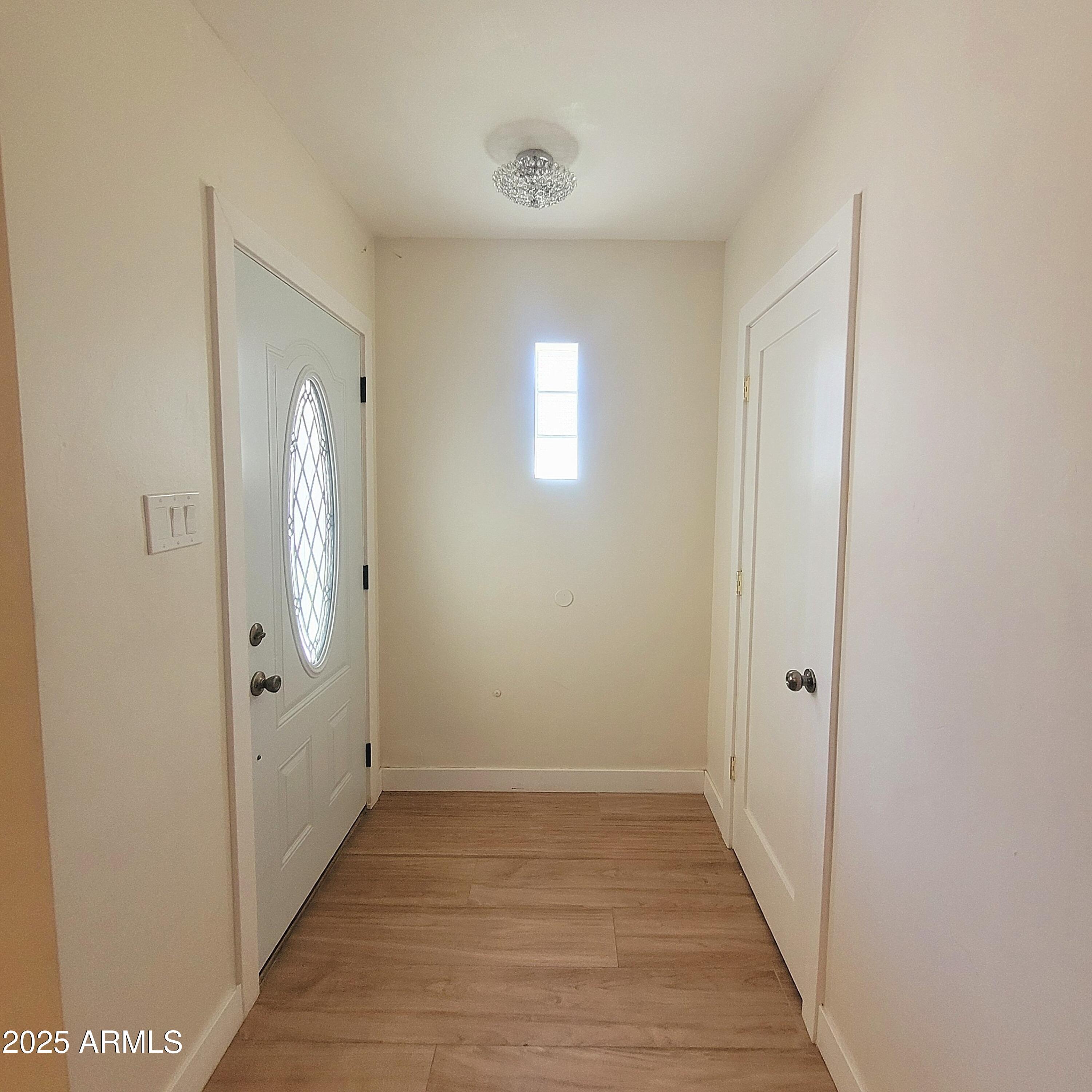4028 East Edgemont Avenue Phoenix, AZ 85018 - Photo 15 of 27 a view of a hallway with wooden floor