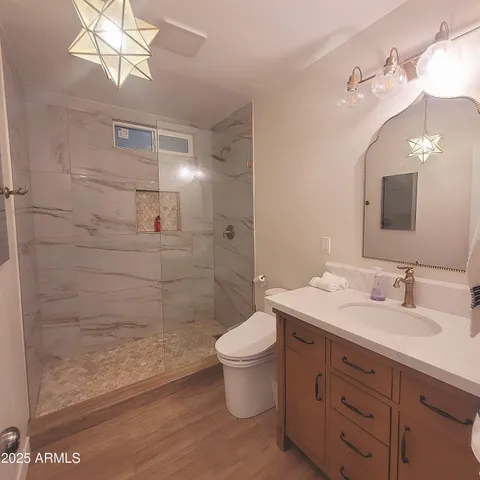 a bathroom with a double vanity sink mirror and toilet