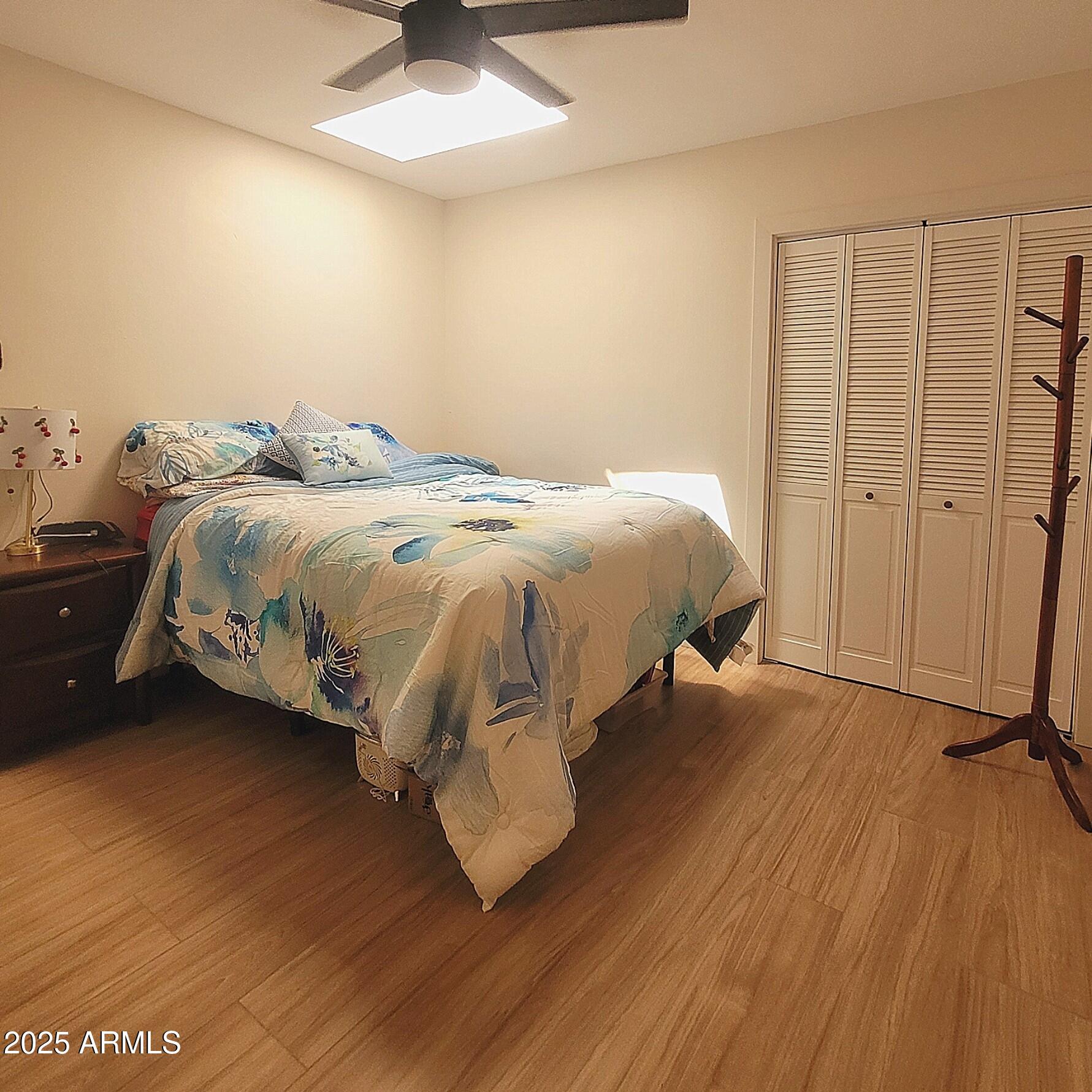 4028 East Edgemont Avenue Phoenix, AZ 85018 - Photo 20 of 27 a bedroom with a bed and a ceiling fan