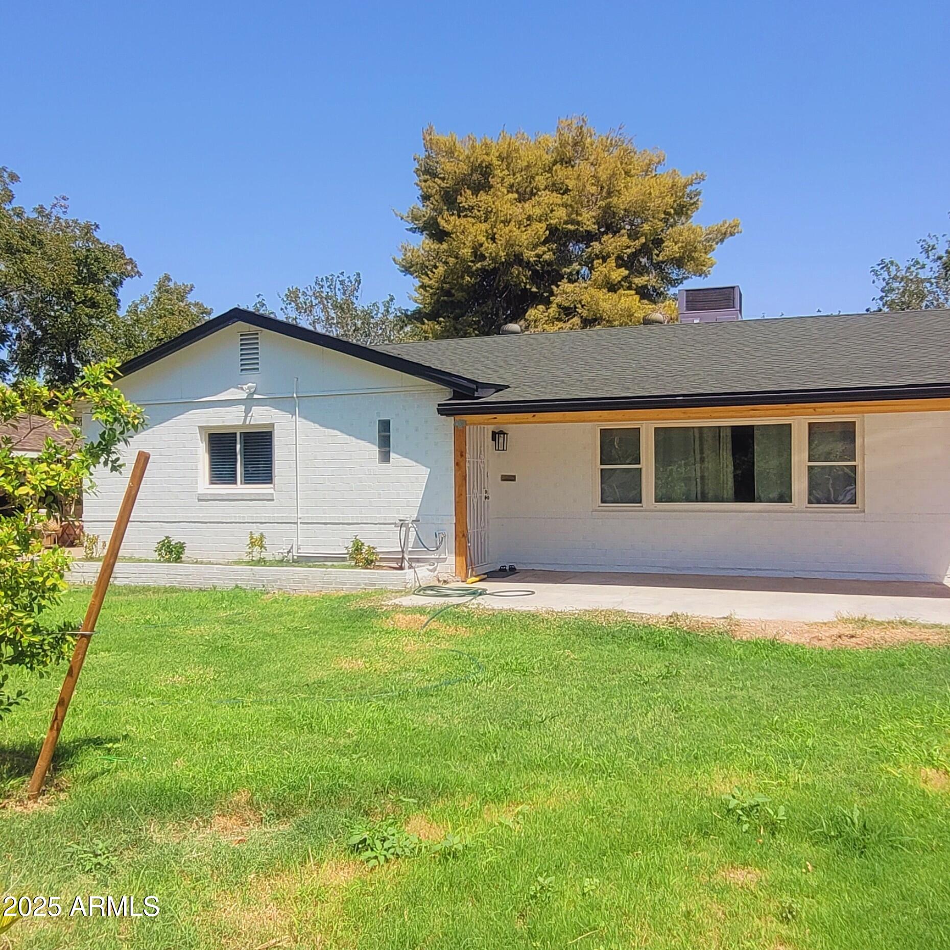 4028 East Edgemont Avenue Phoenix, AZ 85018 - Photo 2 of 27 a backyard of a house with lots of green space