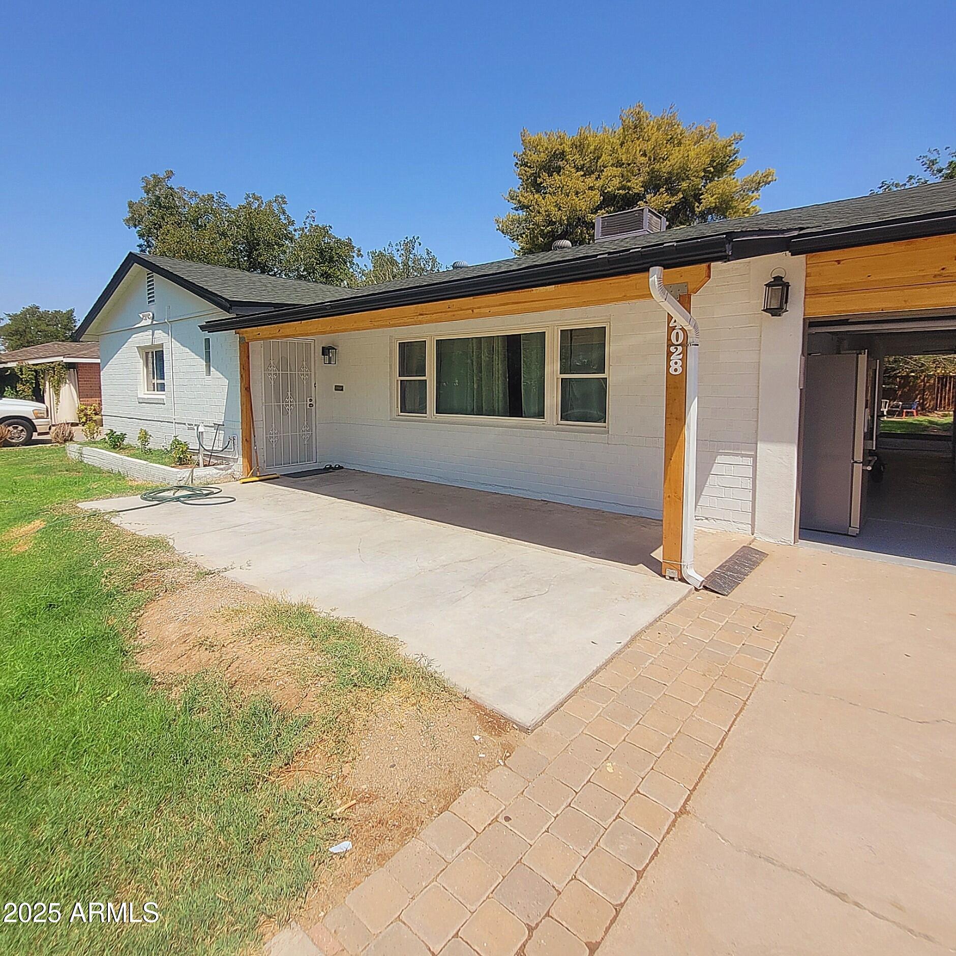 4028 East Edgemont Avenue Phoenix, AZ 85018 - Photo 4 of 27 a front view of a house with a yard and garage
