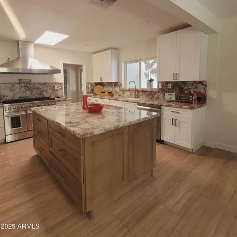 a kitchen with sink stove and cabinets