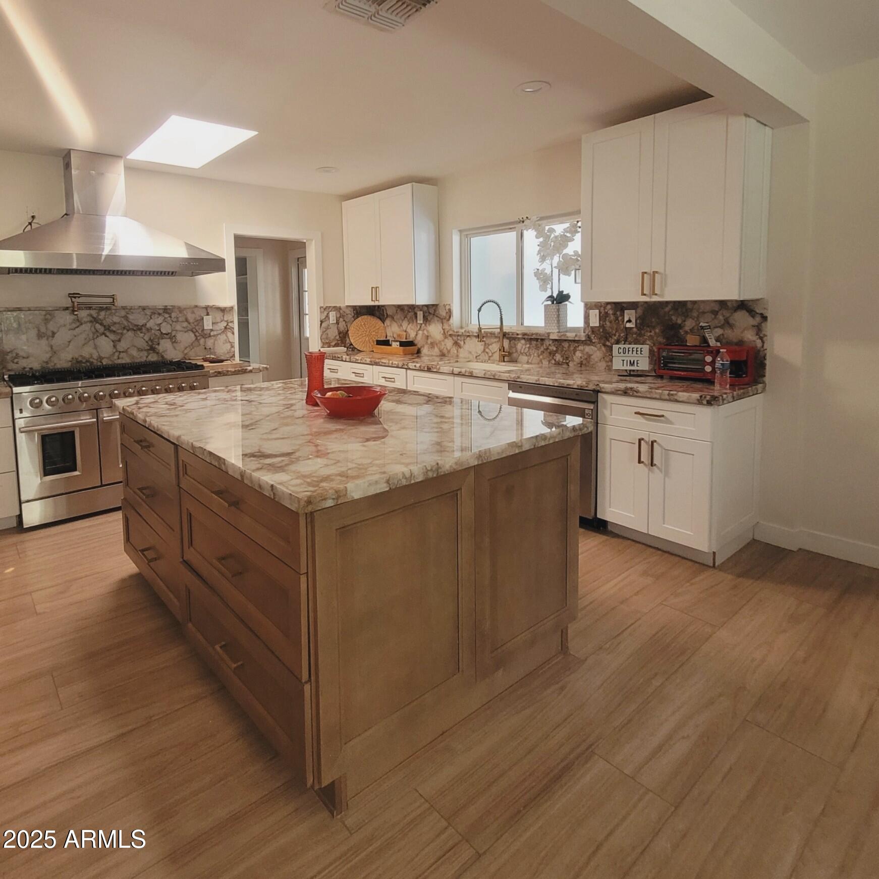 4028 East Edgemont Avenue Phoenix, AZ 85018 - Photo 5 of 27 a kitchen with sink stove and cabinets
