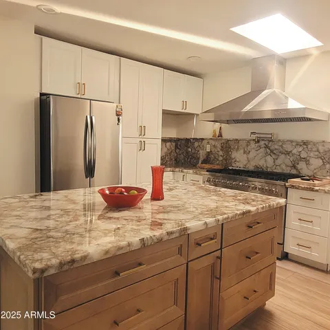 a kitchen with cabinets appliances and a counter space