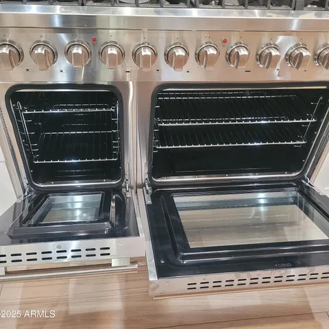 a stove top oven sitting inside of a kitchen