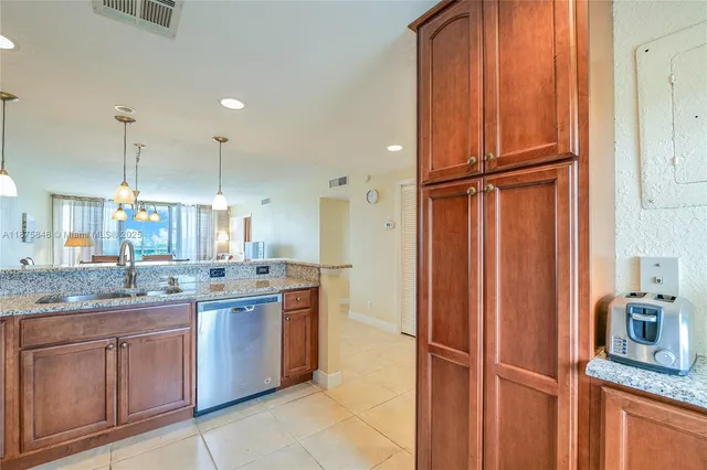 a kitchen with granite countertop stainless steel appliances and counter space