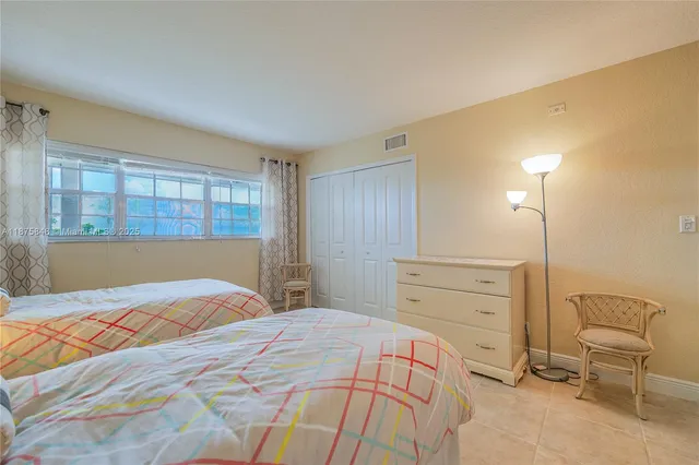 a bedroom with a bed and a chair