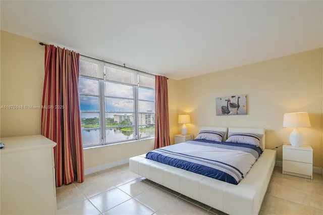 a spacious bedroom with a bed and a window