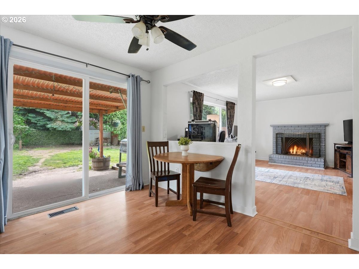 892 Northeast 28th Street Gresham, OR 97030 - Photo 11 of 24 a dining room with furniture a fireplace and wooden floor