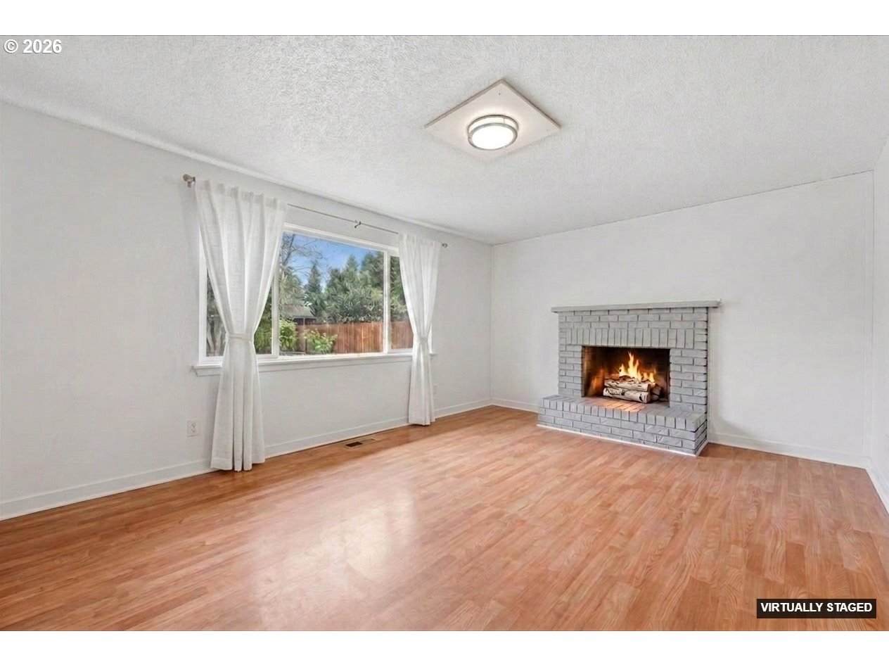 892 Northeast 28th Street Gresham, OR 97030 - Photo 12 of 24 an empty room with windows and fireplace