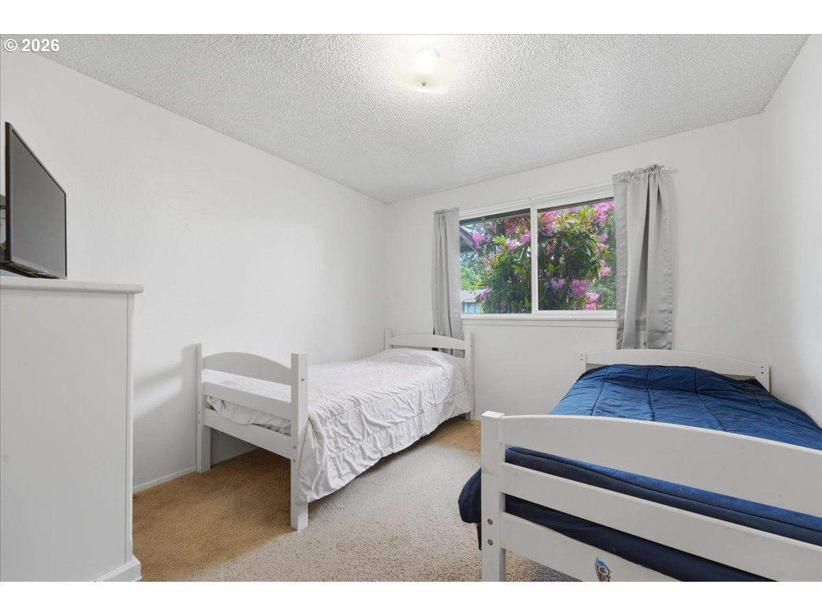 892 Northeast 28th Street Gresham, OR 97030 - Photo 19 of 24 a bedroom with furniture and a window