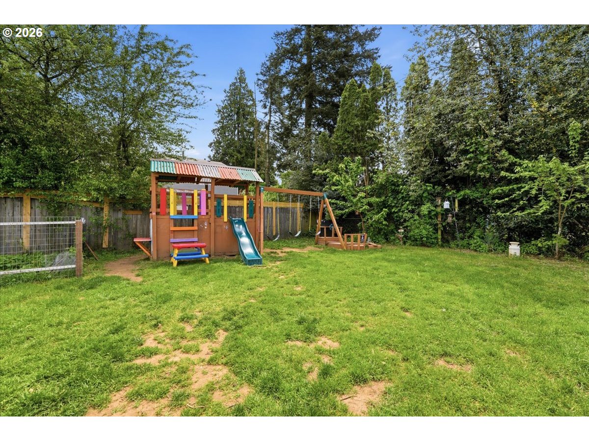 892 Northeast 28th Street Gresham, OR 97030 - Photo 23 of 24 a view of a backyard with table and chairs and wooden fence