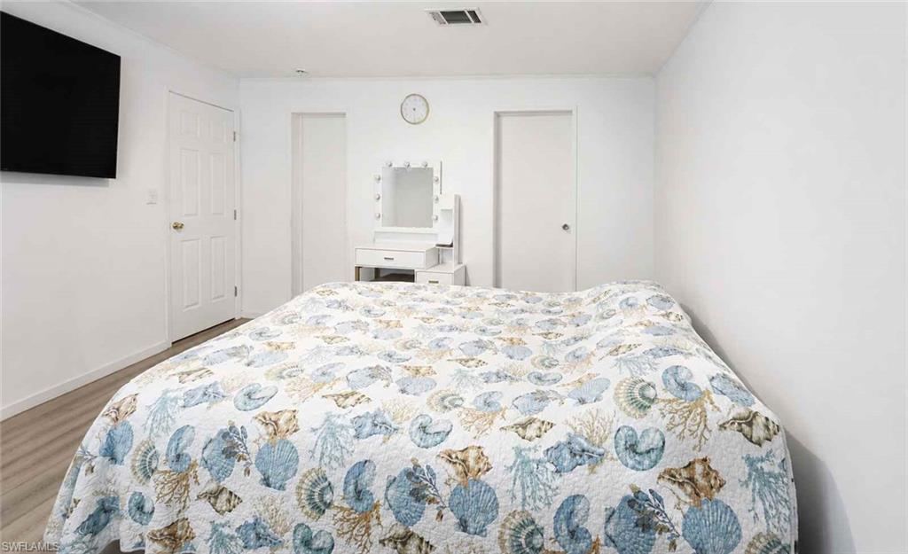 612 Hunting Clb Avenue Montura Ranches, FL 33440 - Photo 24 of 49 a bedroom with a bed and a flat screen tv