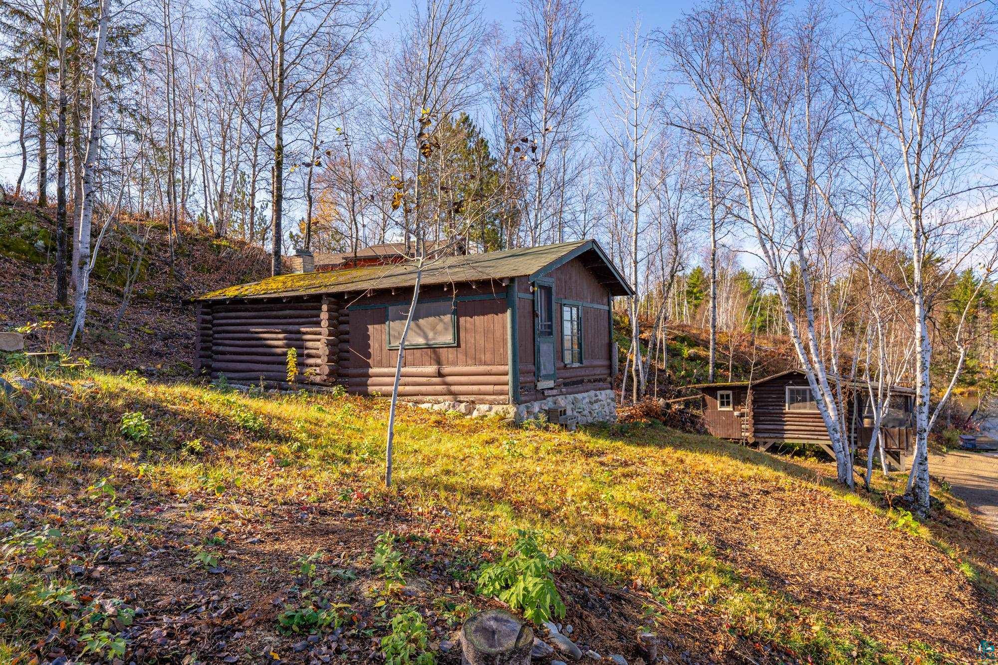 14635 Canadian Border Road Ely, MN 55731 - Photo 60 of 94 Log cabin exterior with natural wood siding and a stone foundation
