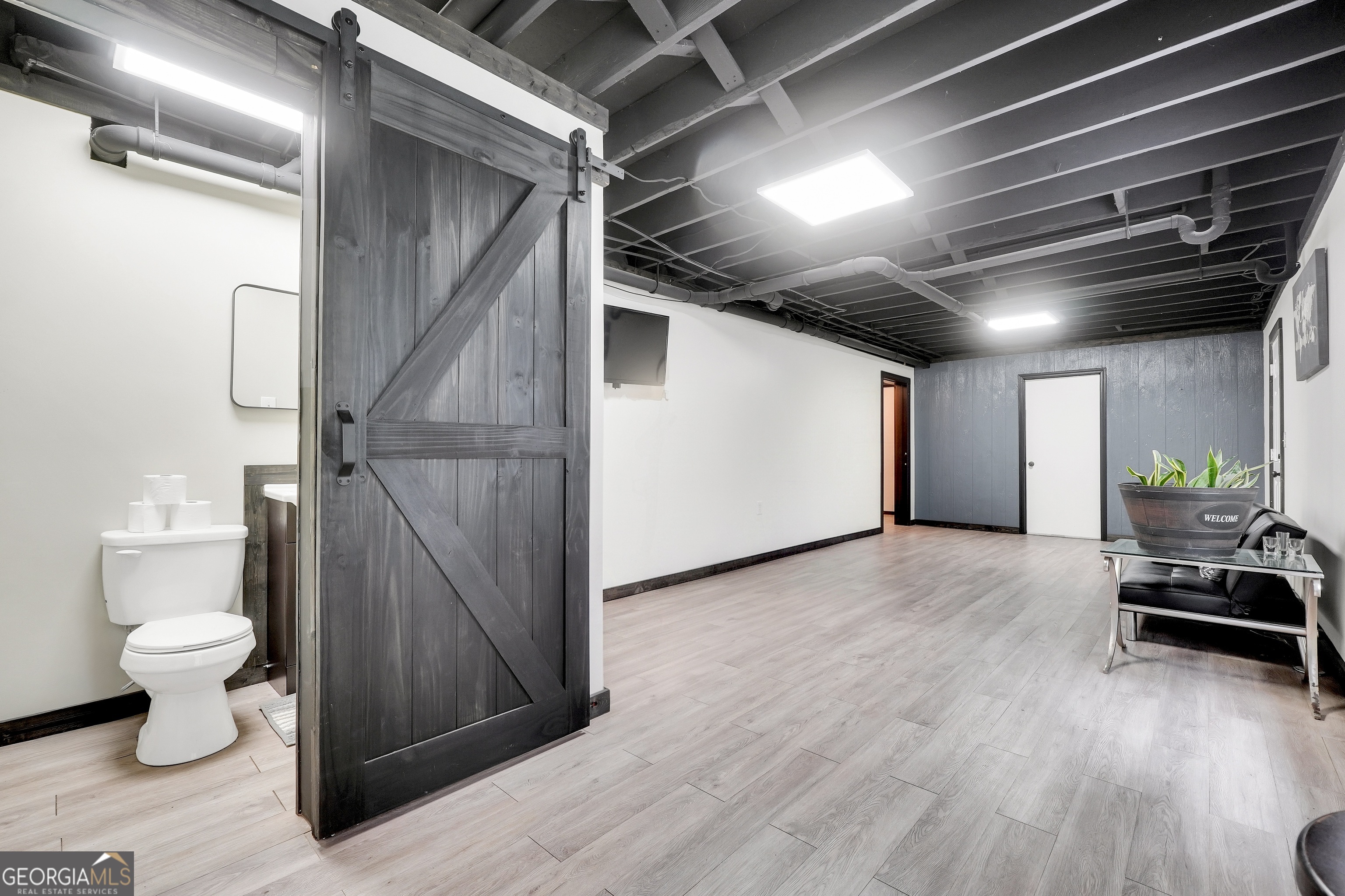 110 Westeria Way Jackson, GA 30233 - Photo 30 of 45 a view of a hallway with wooden floor and a toilet