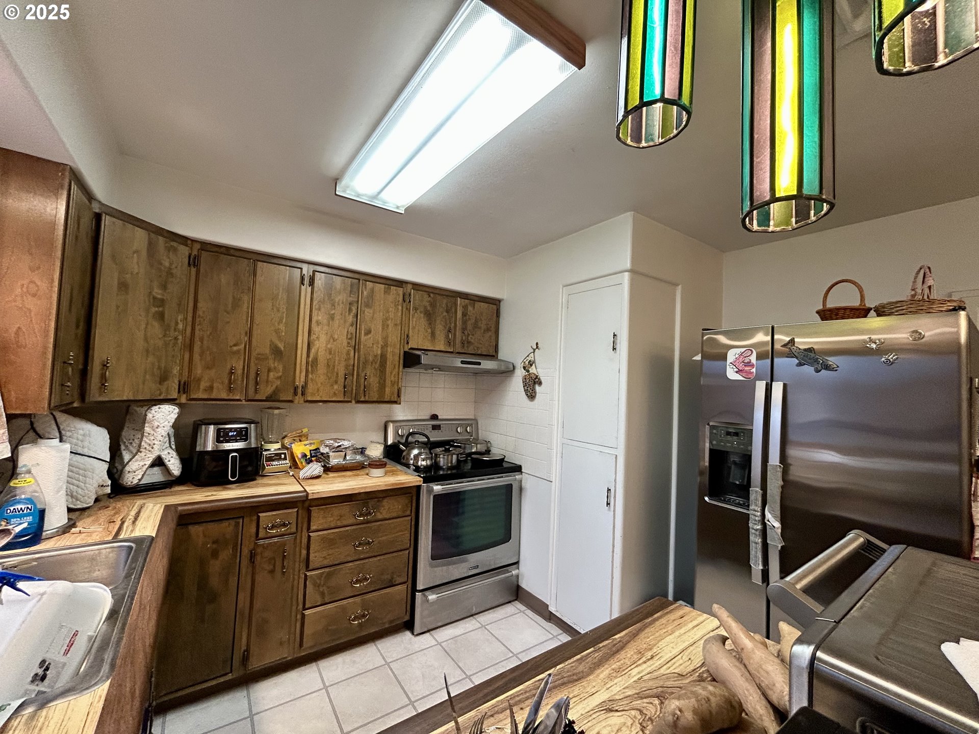 917 Myrtle Street The Dalles, OR 97058 - Photo 14 of 22 a kitchen with a refrigerator sink and cabinets
