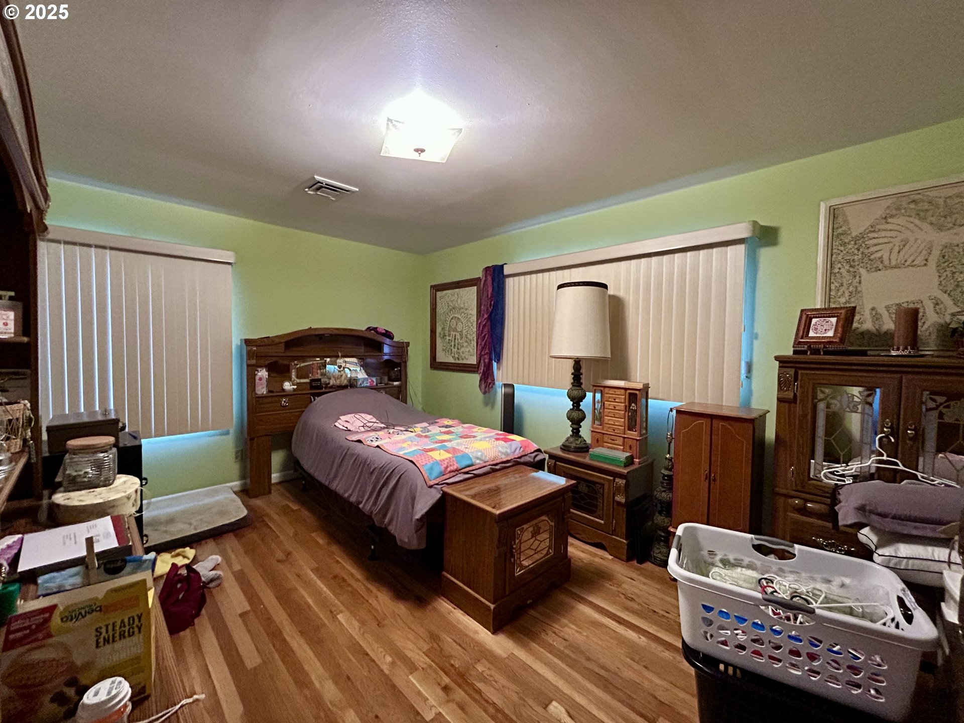 917 Myrtle Street The Dalles, OR 97058 - Photo 15 of 22 a bedroom with a bed and wooden floor