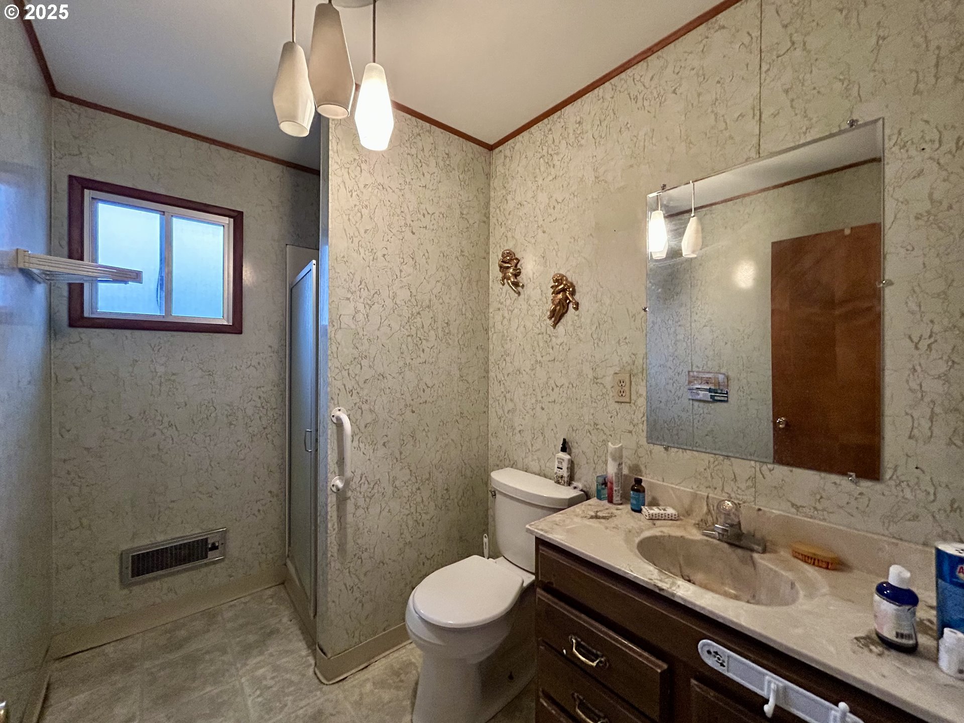 917 Myrtle Street The Dalles, OR 97058 - Photo 19 of 22 a bathroom with a granite countertop toilet sink and shower