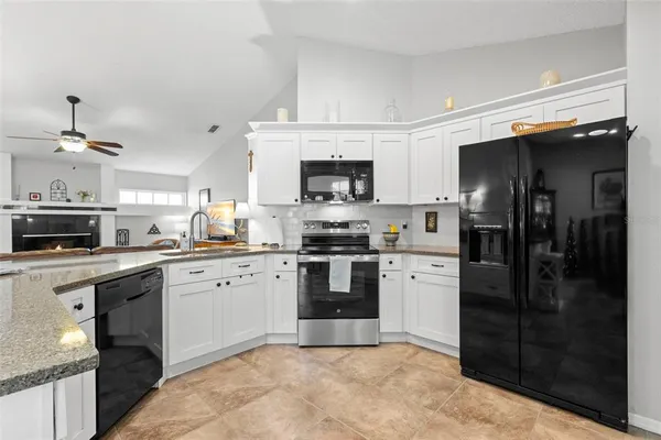 a kitchen with a refrigerator stove and sink