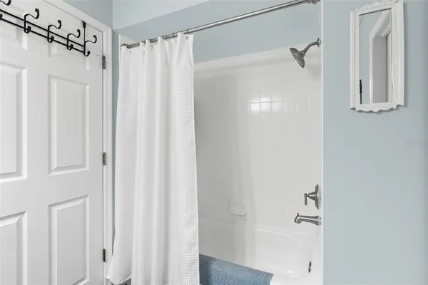 a bathroom with a shower curtain and a shower curtain